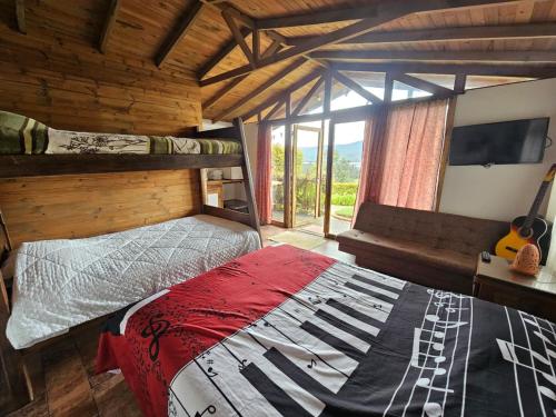 a bedroom with a bed and a large window at Le Ville Guatamonaco in Guatavita