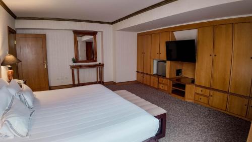 a bedroom with a bed and a flat screen tv at Hotel Miramar in Lima