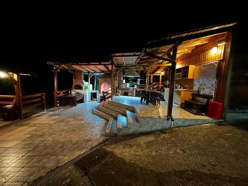 a wooden deck with benches on it at night at Casa Lacului in Malaia