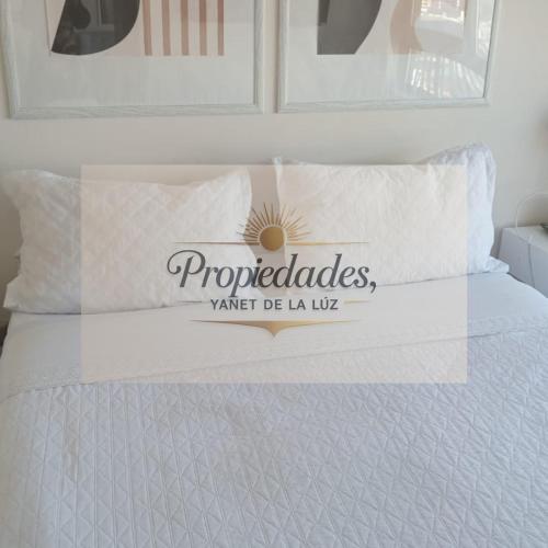 a bed with a sign on top of it at Departamento Central Vip in Antofagasta