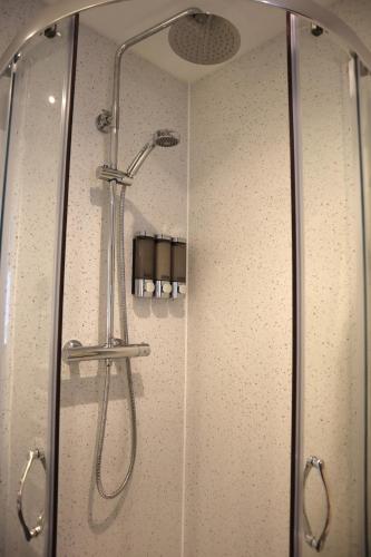a shower with a glass door in a bathroom at Chalfont Haven 