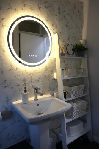 a bathroom with a sink and a mirror at Chalfont Haven 
