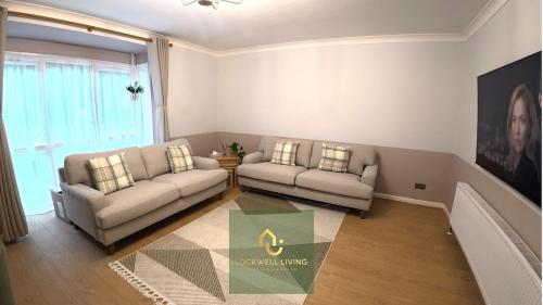 a living room with two couches and a table at Chalfont Haven 