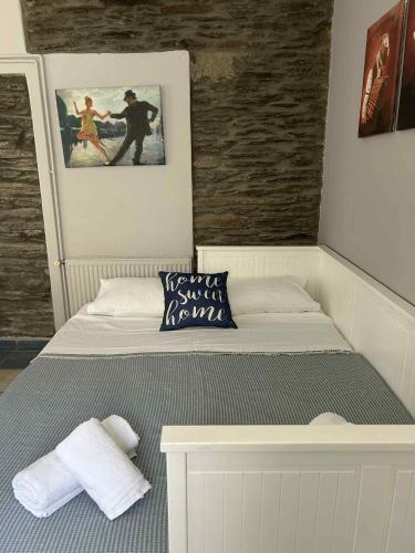 a room with a bed with a picture on the wall at My sweet home Andros in Andros
