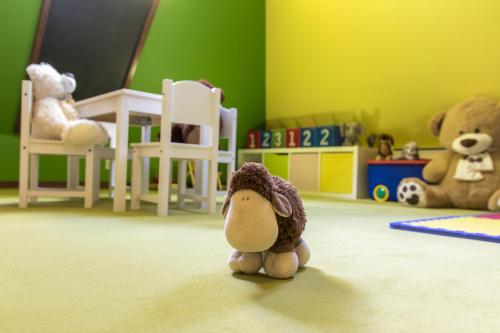 a stuffed animal is sitting in a room at Hotel REDYK Ski&Relax in Zakopane