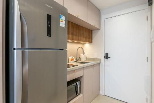 a kitchen with a refrigerator and a sink at Skyline Parque Moinhos by LikeHome in Floresta