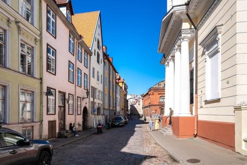 a cobblestone street in a city with buildings at 15th Century Flat with Parking, High Ceilings in Tallinn