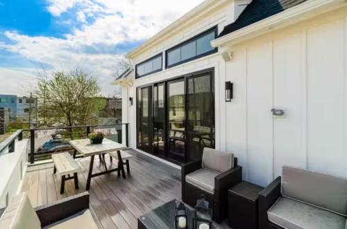 a patio with a table and chairs on a balcony at Jungle House Designer Residences - Downtown Columbus in Columbus