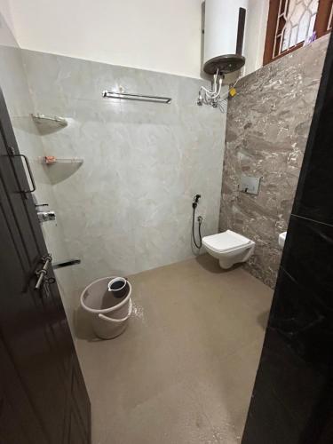 a bathroom with a toilet and a shower in it at Udupi Coral Homestay in Kalyānpur
