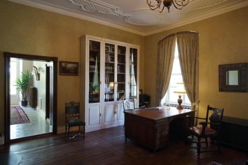 a home office with a desk and a window at Liepupe Manor in Liepupe