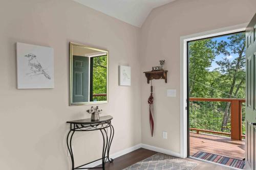 a room with a door and a table and a window at Stone's Throw by Mirror Lake in Highlands