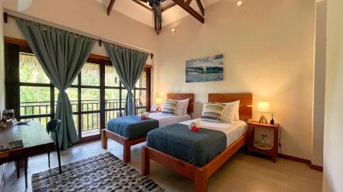 Postel nebo postele na pokoji v ubytování Surfista Villa Siargao