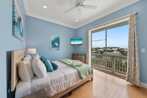 a bedroom with a bed and a balcony at Seaside Bliss at Treasure Circle in Panama City Beach