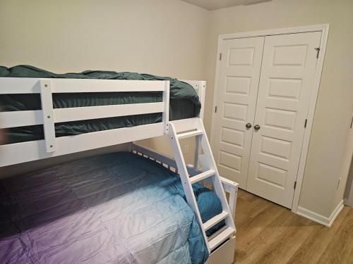 a bedroom with two bunk beds and a door at Brand new Townhouse in Orange Beach