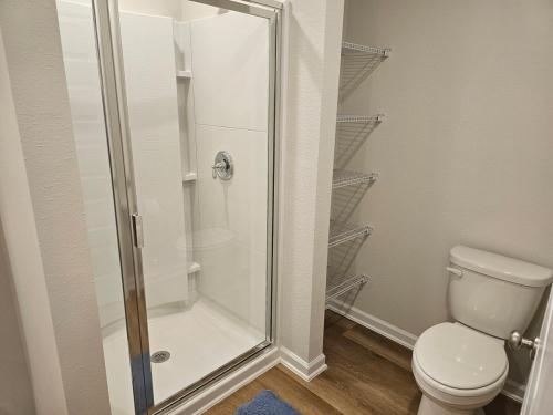 a shower stall in a bathroom with a toilet at Brand new Townhouse in Orange Beach