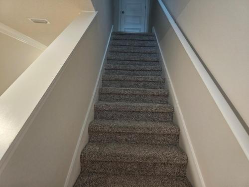 a stairway with a blue door in a room at Brand new Townhouse in Orange Beach