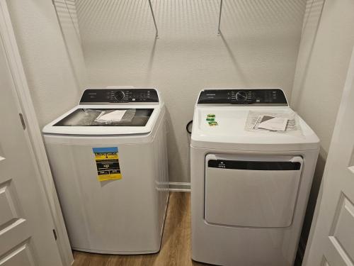 a small kitchen with a stove and a trash can at Brand new Townhouse in Orange Beach