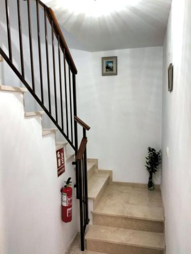a staircase in a home with white walls and wooden floors at Studio Nova in Priego de Córdoba