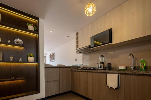a kitchen with wooden cabinets and a counter top at Modern apartment - 10 Min to City Center in Cusco
