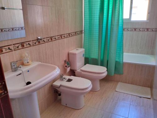 a bathroom with a sink and a toilet and a tub at Studio Nova in Priego de Córdoba
