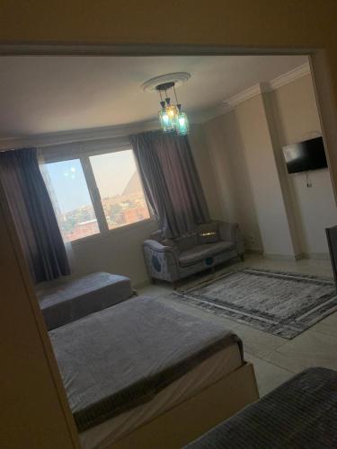 a living room with two beds and a couch at Sneferu Pyramids View in Cairo