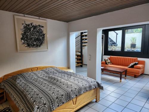 a bedroom with a bed and a couch at Art in Nature in Münzenberg