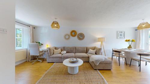 a living room with a couch and a table at 3 Bedroom House with free parking and garden in London