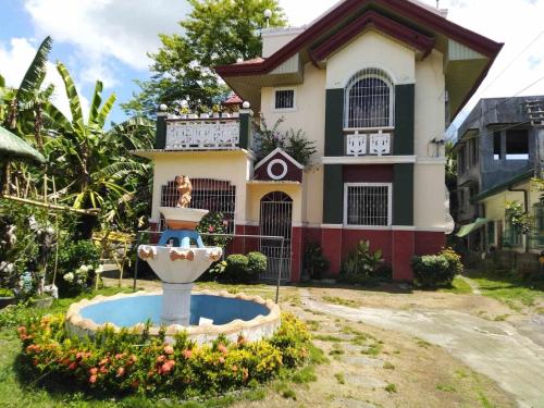 a house with a fountain in front of it at Casa Emilia 
