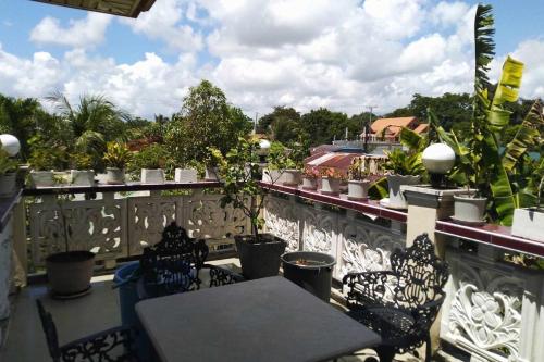 a patio with tables and chairs on a balcony at Casa Emilia 