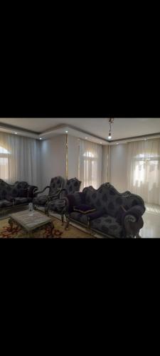 a room with couches and chairs in a room at غرفة مفروشة للايجار in Kafr Mas‘ūd