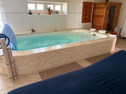 a large bath tub in a room at Calme et confort en Charente , Gîte Les Vignes avec piscine in Saint-Médard