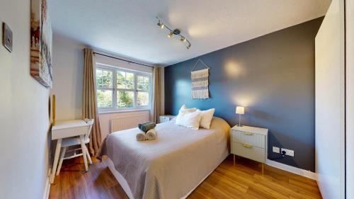 a bedroom with a bed with a teddy bear on it at 3 Bedroom House with free parking and garden in London