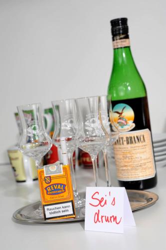 a table with glasses and a bottle of wine at Best Western Hotel Würzburg-Süd in Würzburg