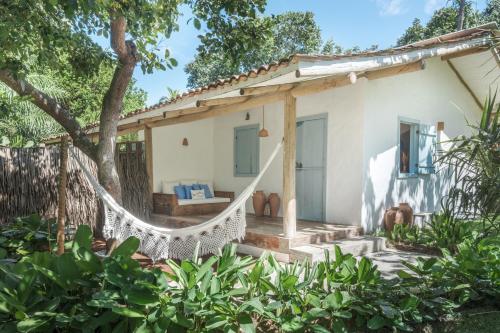 a hammock in front of a house at Vila Oyá - Praia de Algodões in Marau