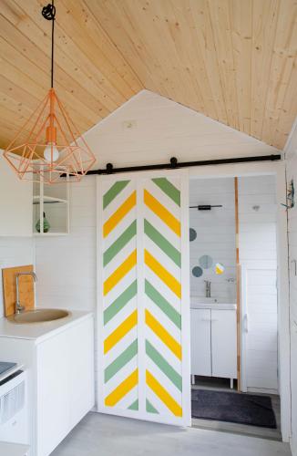 a kitchen with a colorful wall in a room at Pura Vida Downtown Tiny houses in Bucharest