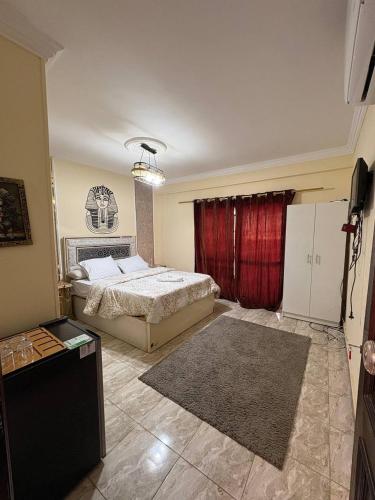 a bedroom with a bed and a red curtain at Sneferu Pyramids View in Cairo