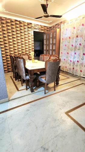a dining room with a table and chairs at 3 Bedroom Apartment - Shri Amarnath Yatra baseCamp in Jammu