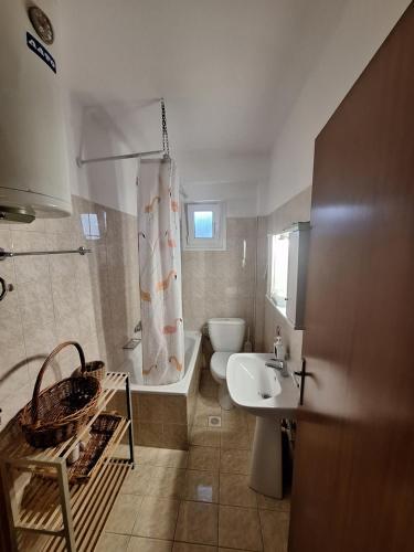 a bathroom with a tub and a toilet and a sink at The Bliss Z1 in Kastoria