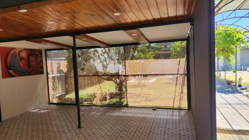 an empty room with a large glass door with a view at Home in Grange