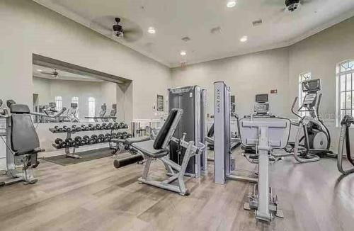 a gym with treadmills and machines in a room at Vista Cay Getaway Luxury Condo by Universal Orlando Rental in Orlando