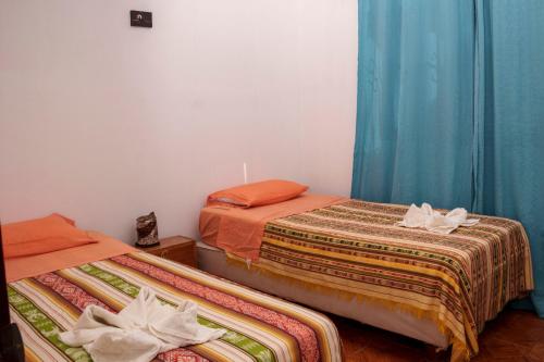 two beds sitting next to each other in a room at My Place in paradise II in San Cristobal