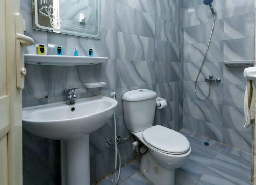 a small bathroom with a toilet and a sink at Sneferu Pyramids View in Cairo