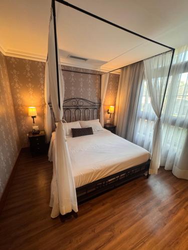 a bedroom with a large bed with a canopy at Buona Vitta Gramado in Gramado