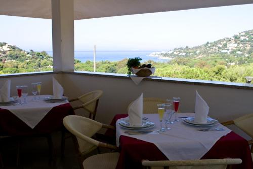 two tables in a restaurant with a view of the ocean at Il Complesso Saraceno in Torre delle Stelle