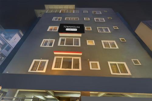 a tall building with a sign on the side of it at Super Townhouse HAL Indiranagar Extension in Bengaluru