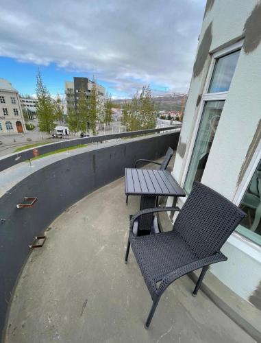 a patio with two chairs and a table on a building at LUXURIOUS COMFORTABLE Family Villaes in Akureyri