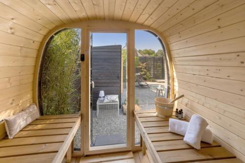 an inside view of a wooden room with a large window at GOETHE49 - Herbstauszeit, private Sauna, Kamin, Ankommen und Wohlfühlen, viel Platz in gemütlicher und erholsamer Atmosphäre in Rielasingen-Worblingen