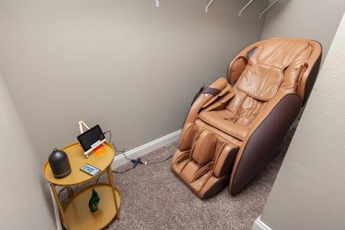 an empty chair in a room with a table at Exclusive, Pool, Massage Chair, Jordan Creek in West Des Moines