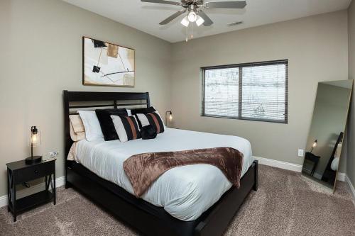 a bedroom with a large bed and a ceiling fan at Exclusive, Pool, Massage Chair, Jordan Creek in West Des Moines