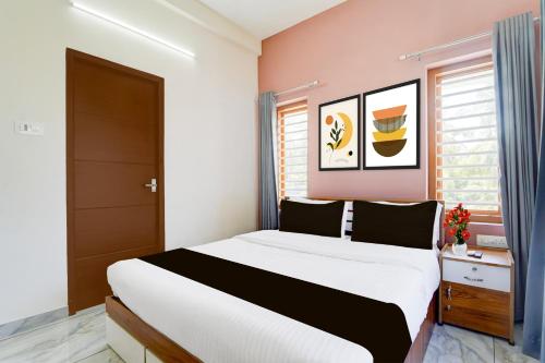 a bedroom with a large bed in a room at Super Collection O Westhill Near Govt Engg College in Calicut